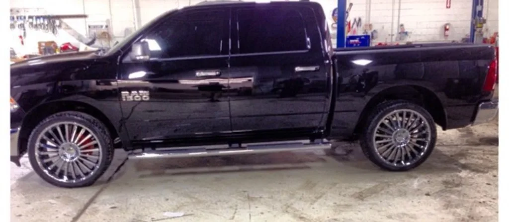 Black RAM 1500 pickup with chrome custom wheels and red brake calipers in Jack's bay